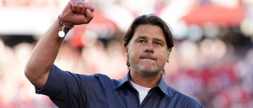 Mauricio Pochettino gestures to supporters as he walks off the pitch after the United States beat Bosnia-Herzegovina at the World Cup