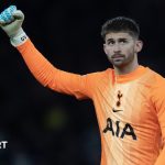 Guglielmo Vicario in an orange Tottenham goalkeeper jersey