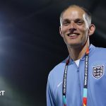 Thomas Tuchel smiles in England training kit with a World Cup 2026 lanyard around his neck